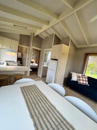 um quarto com uma cama, uma cozinha e um sofá em Wilsons Prom Holiday Park em Yanakie