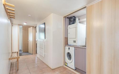 a laundry room with a washer and dryer at Lhotsky 4 in Thredbo