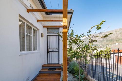 a house with a porch with a glass door at Vintage Charm in Tamboerskloof in Cape Town