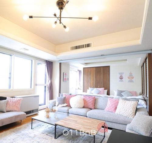 a living room with a couch and a table at NK BLD5F Sapporo 3LDK 3BR 1 floor 1 room in Sapporo