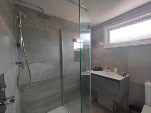 a bathroom with a shower and a sink at Top of the House in Bognor Regis