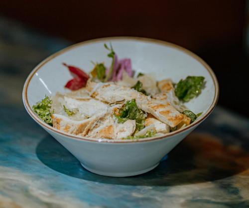 a bowl of food sitting on a table at Hotel Tres Banderas in Manuel Antonio