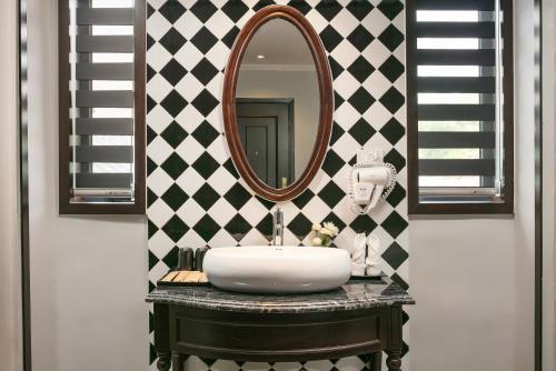 a bathroom with a sink and a mirror at Salute Premium Hotel & Spa in Hanoi