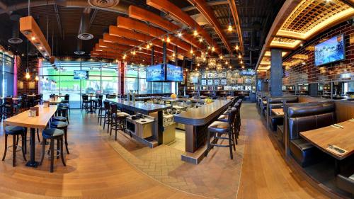 a restaurant with tables and chairs and a bar at Cozy 3BD w/AC, Patio, Theatre Room, 15 min to DT in Edmonton