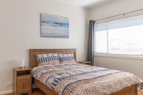 a bedroom with a bed and a window at Bright and Breezy in Sussex inlet