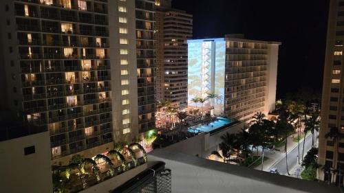 a view of a city at night with tall buildings at Waikiki Condo 2 Bedrooms 2 Bathrooms with 1 free parking space in Honolulu