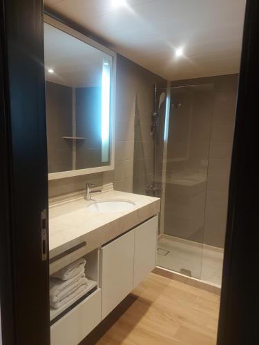 a bathroom with a sink and a shower at Castel Mare Beach Hotel & Resort in Jbeil