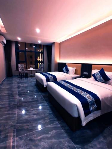 a hotel room with three beds in it at 东方酒店 in Sihanoukville