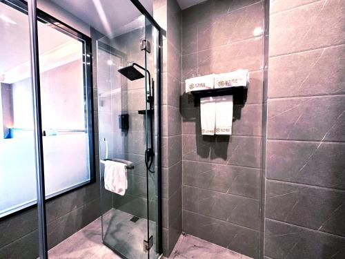 a bathroom with a shower with a glass door at 东方酒店 in Sihanoukville