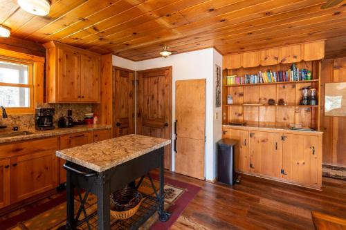 a kitchen with wooden cabinets and a counter top at Along The River in Yosemite West