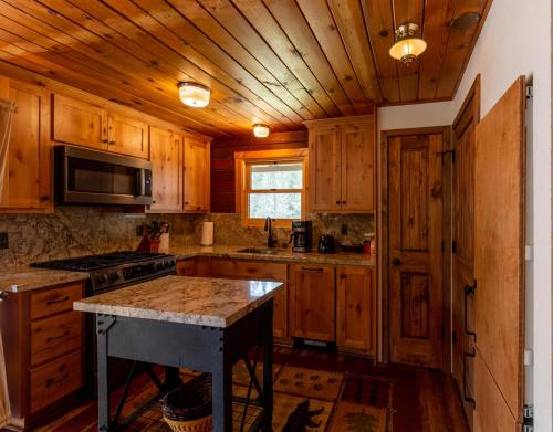 a kitchen with wooden cabinets and a counter top at Along The River in Yosemite West