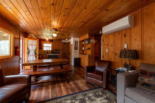 a living room with a couch and a table in a cabin at Along The River in Yosemite West