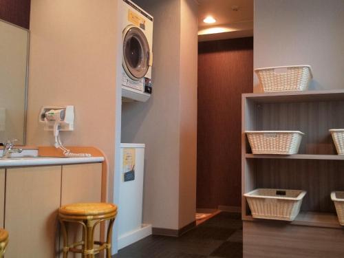 a bathroom with a washer and a sink and a washing machine at Hotel Route-Inn Tsu Ekiminami -Kokudo23gou- in Tsu