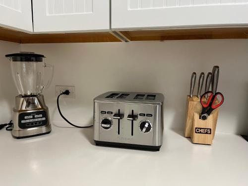 a kitchen counter with a blender and scissors on it at Waikiki Condo 2 Bedrooms 2 Bathrooms with 1 free parking space in Honolulu