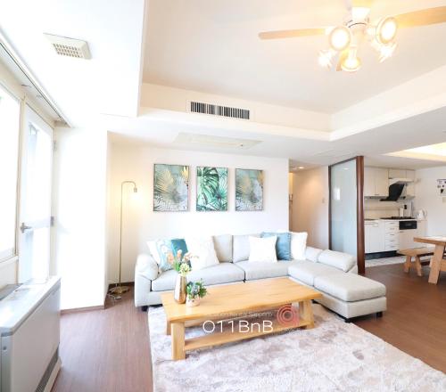 a living room with a couch and a table at NK BLD6F Sapporo 3LDK 3BR 1 floor 1 room in Sapporo