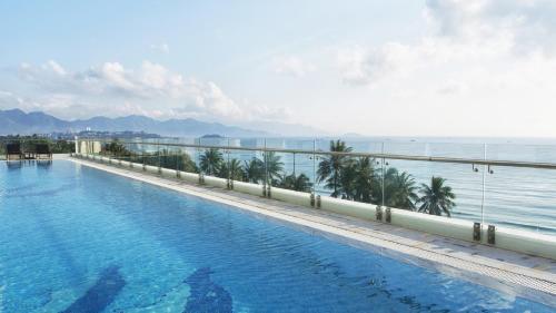 a swimming pool with a view of the ocean at Havana Nha Trang Hotel in Nha Trang