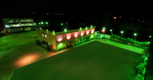 a building with green lights on it at night at Hotel Balaji Central in Ratlām