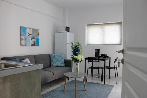 a living room with a couch and a table with flowers at Amalia Residences in Nicosia