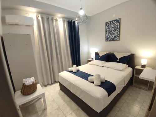 a bedroom with a large bed with blue and white pillows at TRAVELLERS HOUSE in Volos