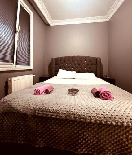 a bedroom with a bed with pink towels on it at Venüs apart in Istanbul