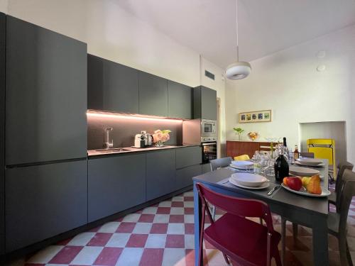 a kitchen with a table and a dining room at Villa Pia Lena in Magreglio