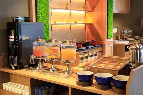 a kitchen with a counter with a bar with drinks at QuintessaHotel FukuokaHakata Relax&Sleep in Fukuoka
