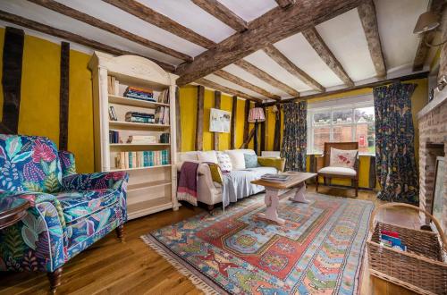 a living room with a couch and a table at Pats' Place Long Melford in Sudbury