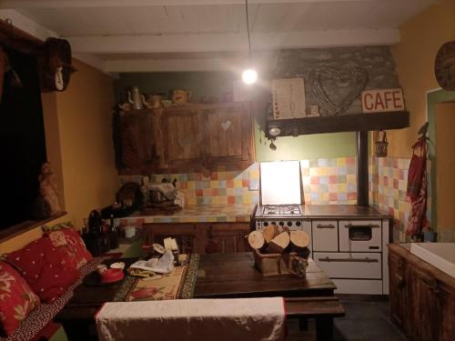 a kitchen with a stove and a table in a room at Maison du Mont in Aosta