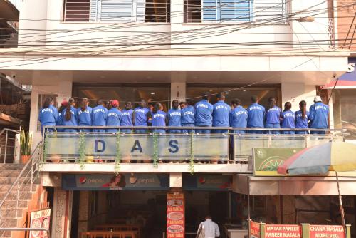 a group of people standing on the balcony of a building at DAS HOTEL in Darjeeling