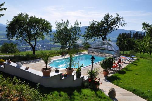 a swimming pool with plants in a yard at Gesundheitshof Lohninger in Mondsee