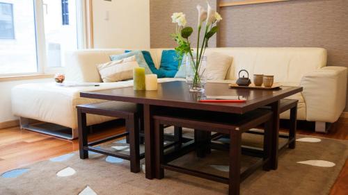 a living room with a coffee table and a couch at Yuki Yama Apartments in Kutchan