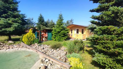 a house with a train track in the middle of a yard at Chata Rovnáčov in Studenec