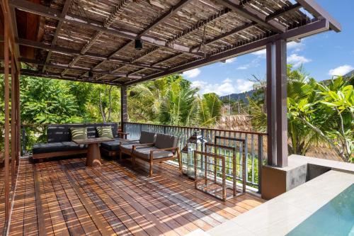 a patio with a couch and chairs on a deck at Irene Pool Villa Resort, Koh Lipe in Ko Lipe