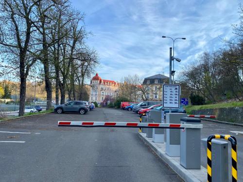 a parking lot with cars parked on a street at Top class apartments in Carlsbad Bulharska street in Karlovy Vary