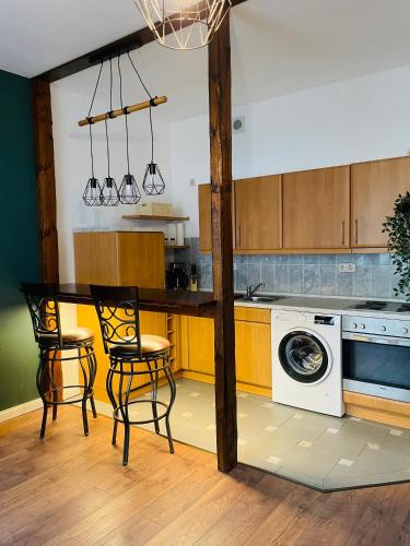 a kitchen with a table and chairs and a washing machine at Behaglichkeit und kurze Wege in Schwerin