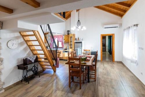 a kitchen and dining room with a table and chairs at Villa Menalo in Neum