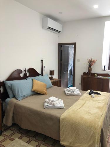a bedroom with a large bed with towels on it at 64 Barth in Msida