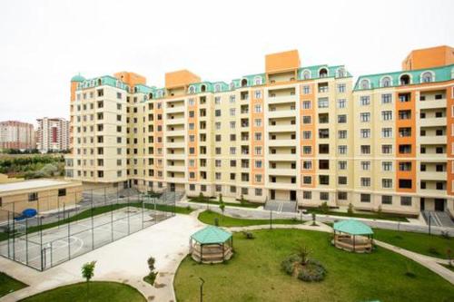 a large building with a park in front of it at VIP апартамент in Sumqayyt
