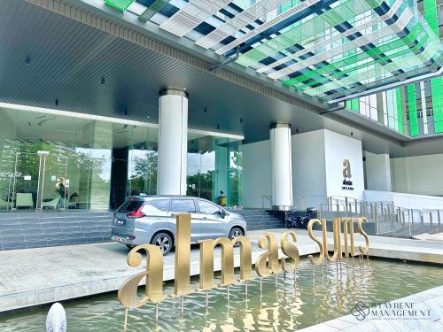 a car parked in front of a building at Almas Suites Puteri Harbour by Stayrene in Nusajaya