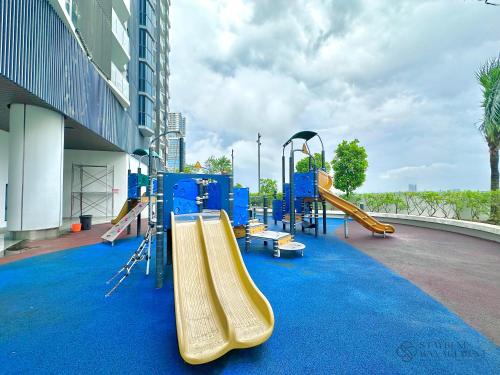 a playground in a building with a slide at Almas Suites Puteri Harbour by Stayrene in Nusajaya