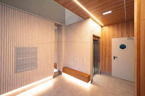a hallway with a door in a room with wooden walls at La Terraza De Loyola in Oviedo