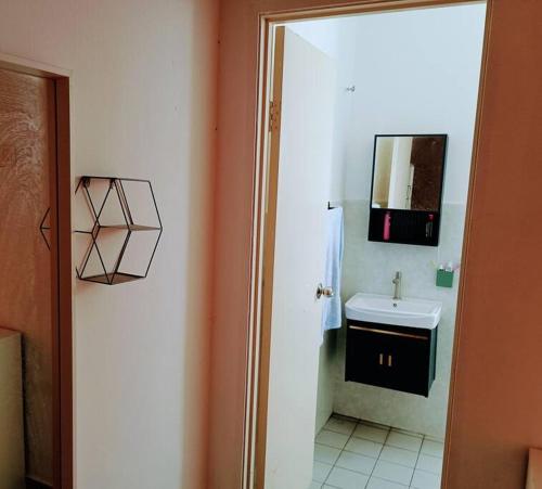 a bathroom with a sink and a mirror at Tenang Retreat Holiday Home in Kajang