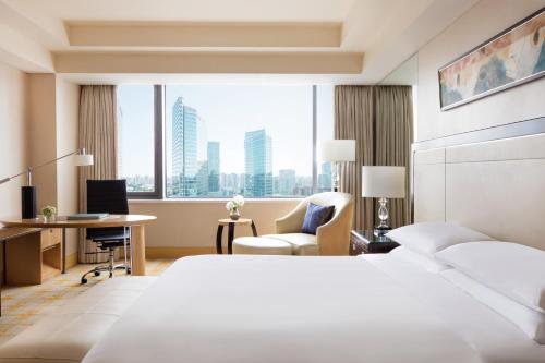 um quarto de hotel com uma cama e uma secretária em JW Marriott Hotel Beijing em Pequim
