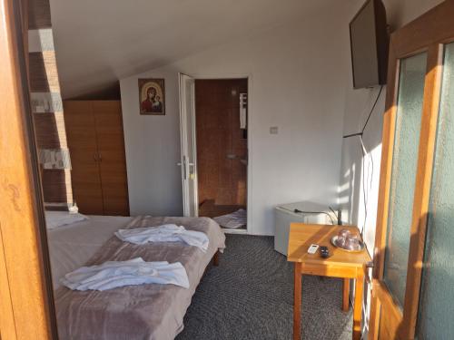 a hotel room with two beds and a table at Vila Ioana & Mirel in Eforie Sud