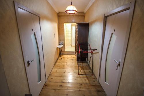 a hallway with two doors and a wooden floor at house by the river in Mestia