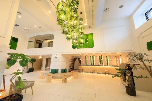 a large lobby with a chandelier in a building at QuintessaHotel SapporoSusukino63 Relax&Spa in Sapporo