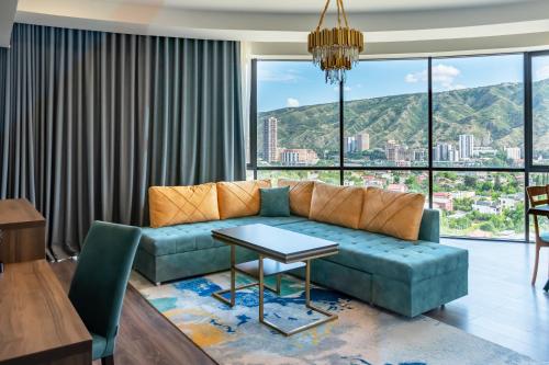 a living room with a couch and a table at Royal Tulip Hotel & Casino, Tbilisi in Tbilisi City