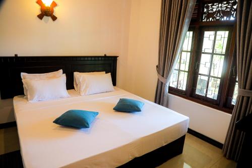 Ένα ή περισσότερα κρεβάτια σε δωμάτιο στο Villana Villa Bentota