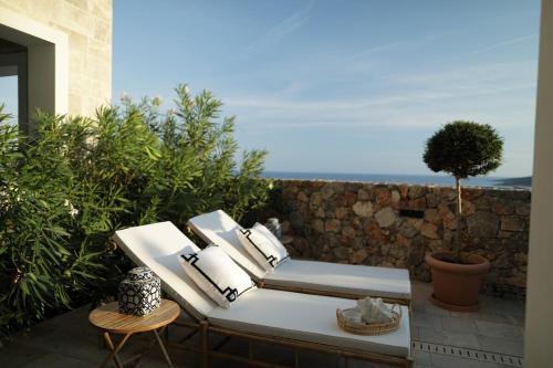a patio with two chairs and the ocean in the background at Apartment Vista By 2bhome in Radovići