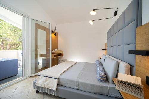 a bedroom with a bed and a large window at Elbitat Homes in Bagnaia